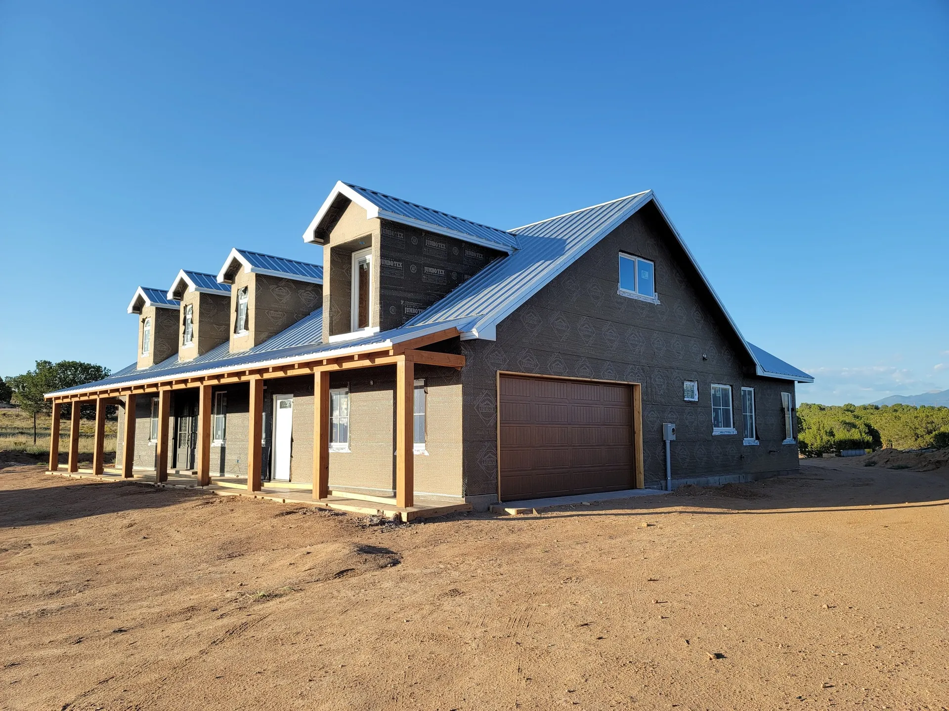 New custom home with covered porch built by Plumbline LLC